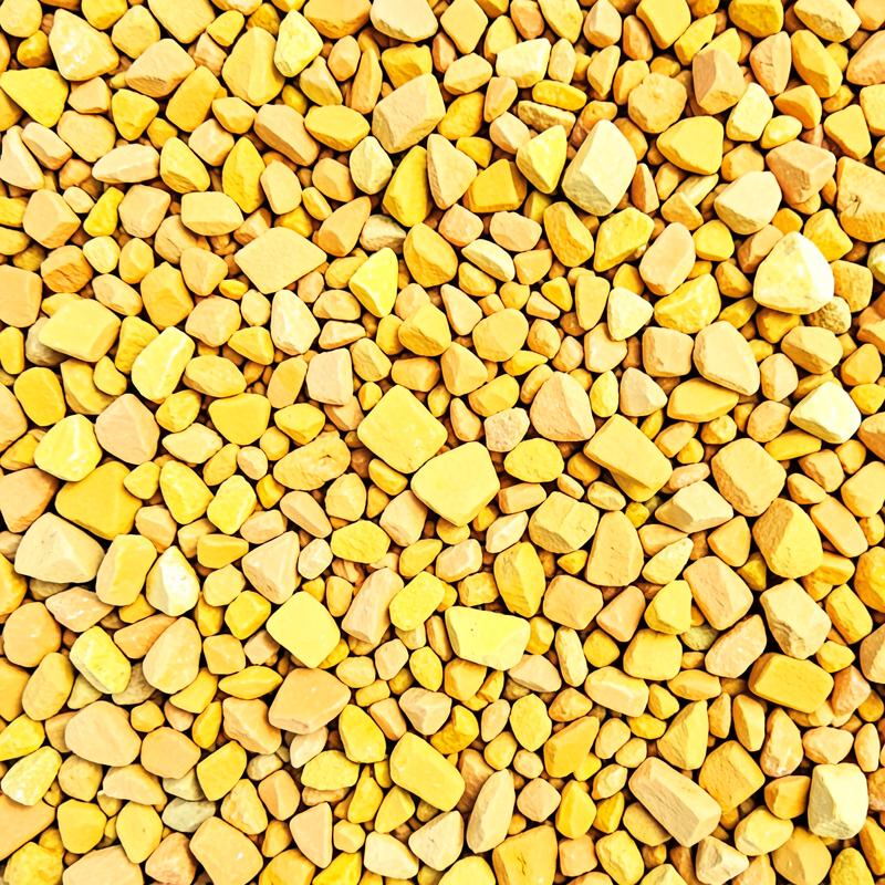 Yellow marble chips with sandy warm tones filling the frame